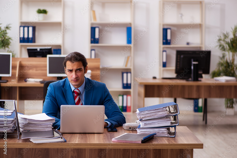 Young male employee working in the office