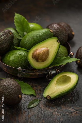 Fresh avocados in a vintage dish on the table.