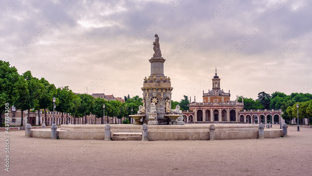 Square and fountain of royal palace with statue in cloudy day at sunset. Aranjuez Madrid.