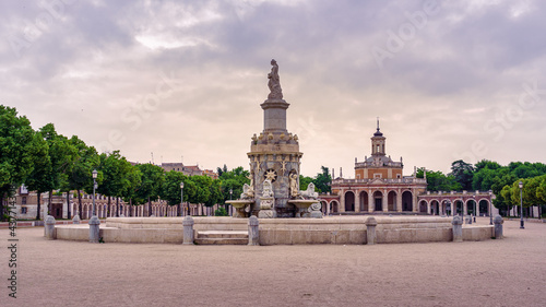 Square and fountain of royal palace with statue in cloudy day at sunset. Aranjuez Madrid.