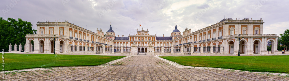 Great panoramic view of the main façade of the Aranjuez palace on a cloudy day at dawn. Madrid.