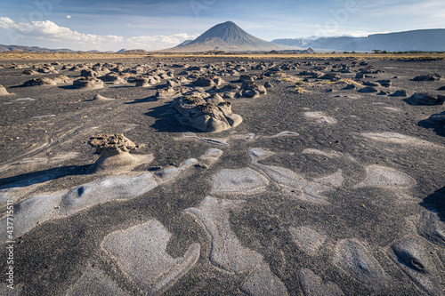 Mudflats close to Lake Natron with Ol Doinyo Lengai volcano in the background; Tanzania