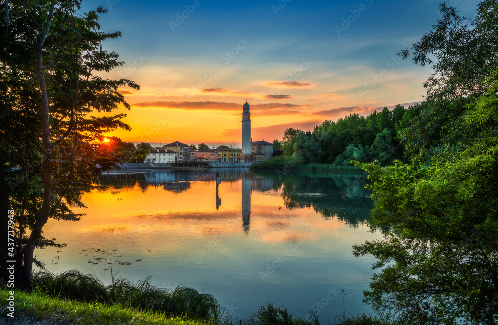 Fototapeta premium The Sile river at sunset, on the background the Casier harbour and church. photo taken on the restera walkway.