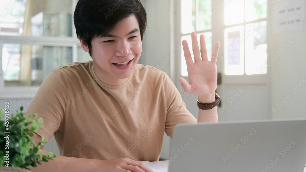 asian man using smart phone and laptop with social network working at home office.Business finances and accounting concept