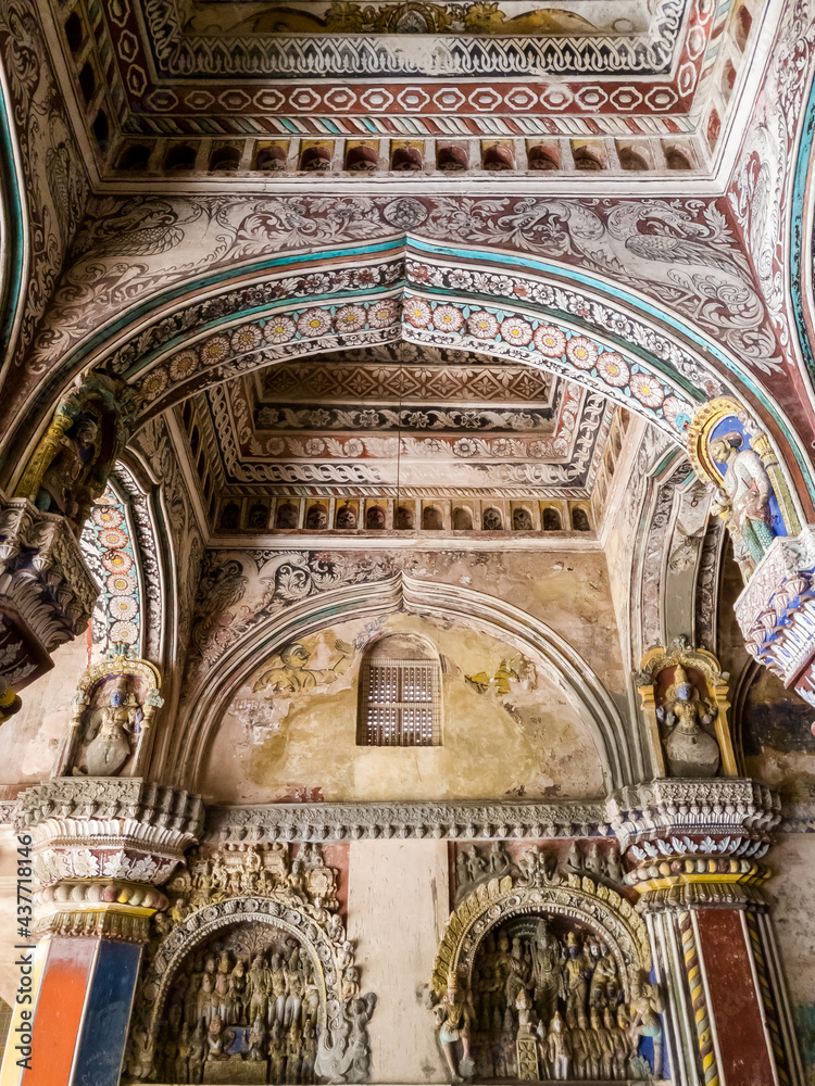 The high arches and colorfully painted walls and ceilings of the ancient 17th century Maratha Palace in the town of Thanjavur.