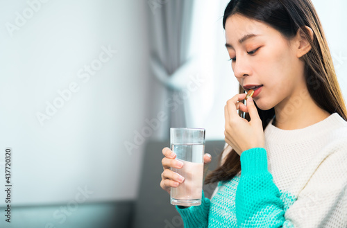 young beauty asian  Pregnant woman  holding vitamin pill isolated at home.healthcare and medical concept.