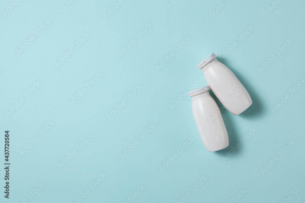 Bottles with probiotics and prebiotics dairy drink on light blue background. Bottles with probiotics and prebiotics dairy drink on light blue background.