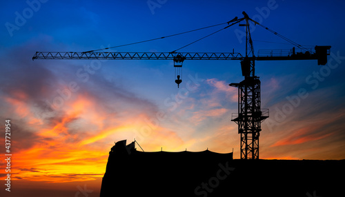 Crane for construction site equipment on sunset background with clipping path