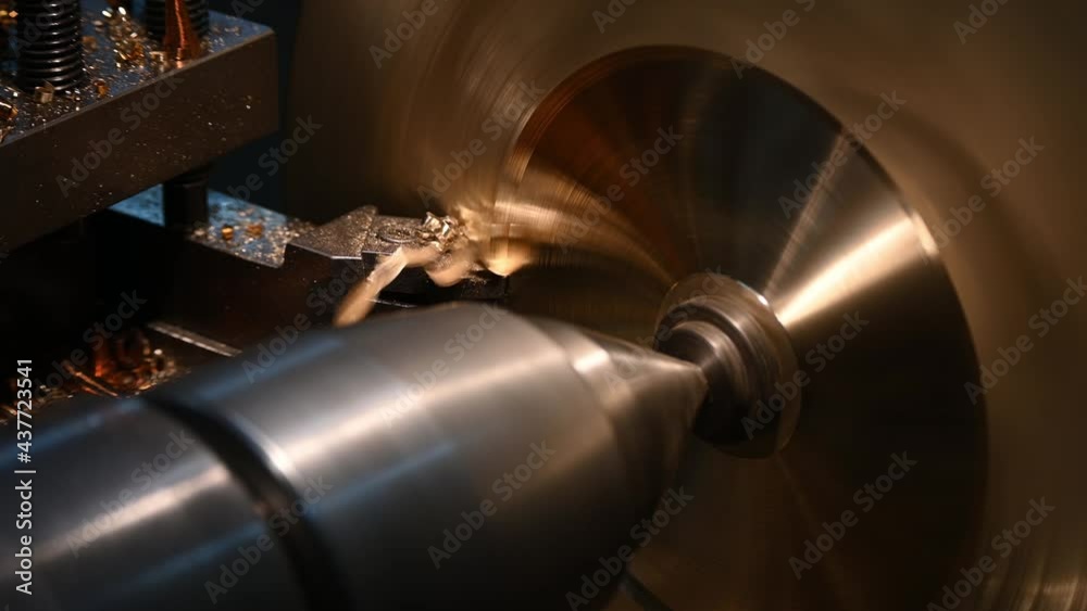 The operation of lathe machine cutting the brass shaft material. The metalworking process by turning machine. The operation of lathe machine cutting the brass shaft material. The metalworking process by turning machine.