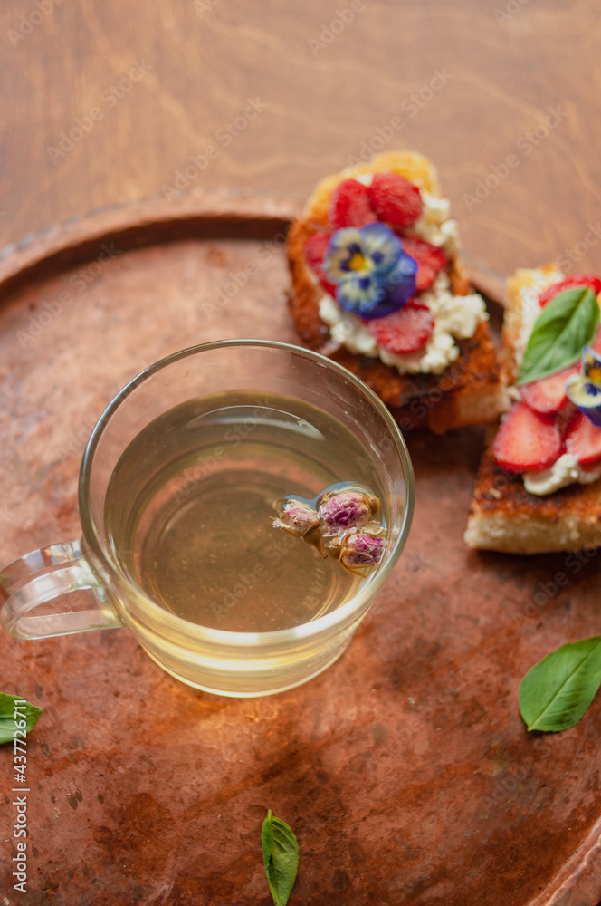 Strawberry toast brioche with cream cheese decorated with flowers and basil fflat lay close up Strawberry toast brioche with cream cheese decorated with flowers and basil fflat lay close up