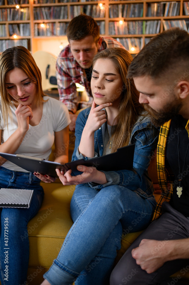 A group of young students studying for their exam together at home