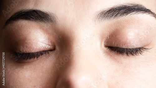 Close up shot of a pair of closed woman's eyes