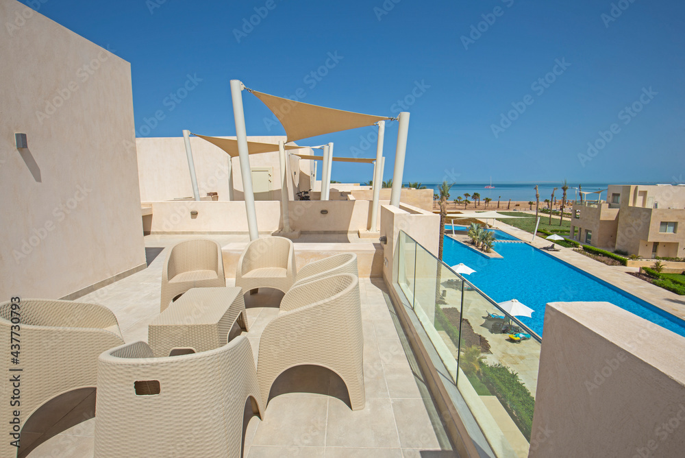 Roof terrace with chairs in tropical luxury apartment resort