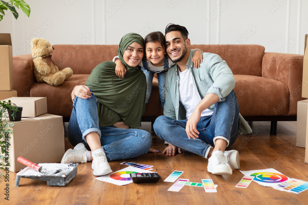 Happy muslim family doing repair in new house Happy muslim family doing repair in new house