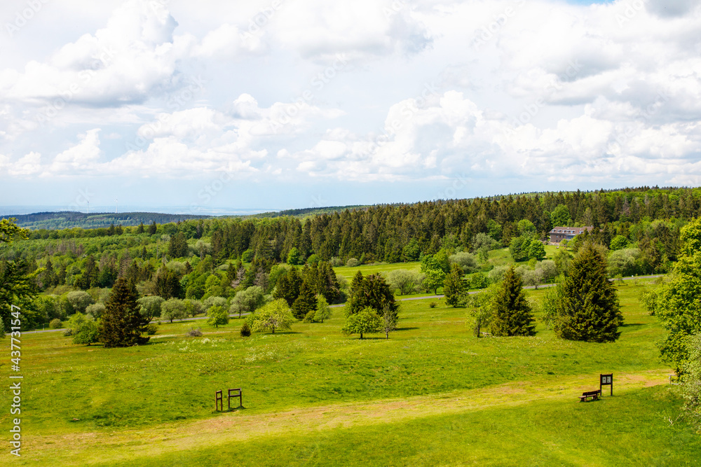 Fototapeta premium Landscape on Hoherodskopf, volcano region in Hesse, Germany. On cloudy sunny warm summer day, meadows, hills, fields and forests.