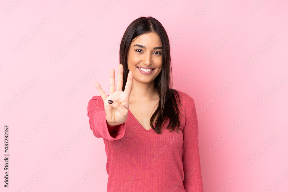Young caucasian woman over isolated background happy and counting four with fingers Young caucasian woman over isolated background happy and counting four with fingers