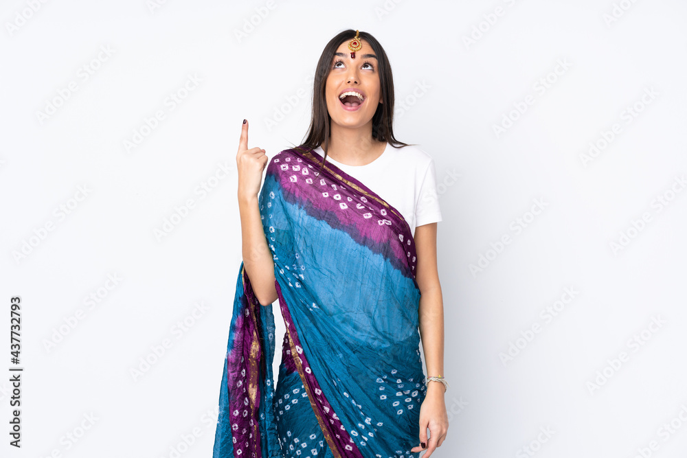 Young Indian woman isolated on white background pointing up and surprised Young Indian woman isolated on white background pointing up and surprised