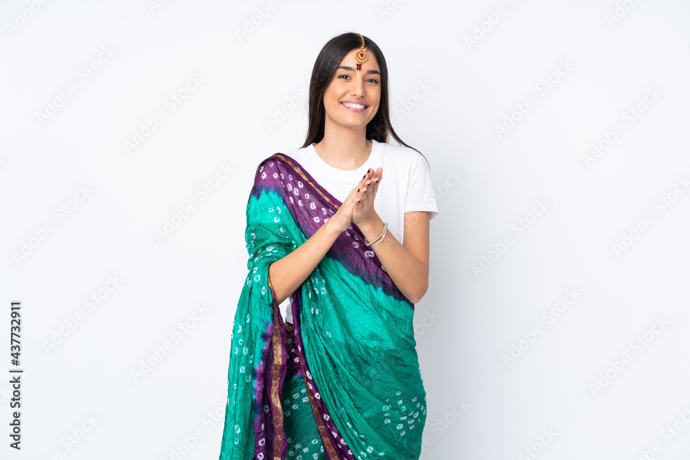 Young Indian woman isolated on white background applauding after presentation in a conference Young Indian woman isolated on white background applauding after presentation in a conference
