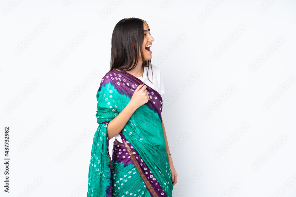Young Indian woman isolated on white background laughing in lateral position Young Indian woman isolated on white background laughing in lateral position