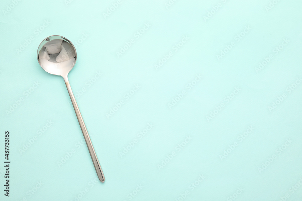 Clean spoon on color background Clean spoon on color background