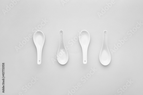 Clean spoons on grey background