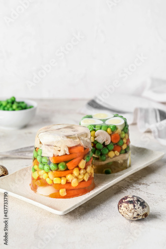 Plate with tasty aspic on table