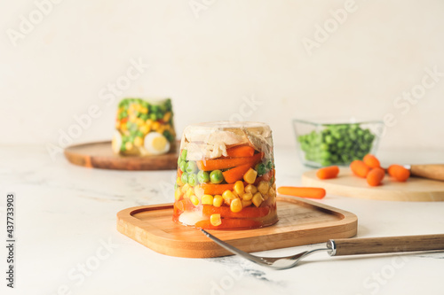 Board with tasty aspic on table