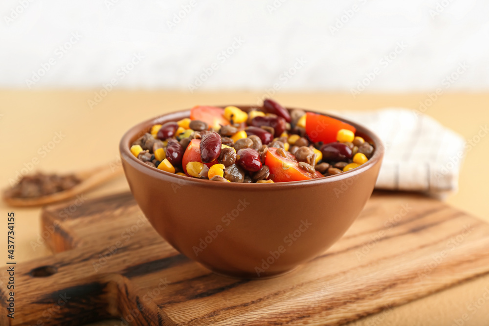 Bowl of tasty cooked lentils, beans and vegetables on table Bowl of tasty cooked lentils, beans and vegetables on table