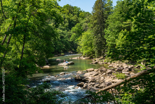 Fototapeta Naklejka Na Ścianę i Meble -  Visitors and families swim in the river at the Audra State Park near Buckhannon in West Virginia
