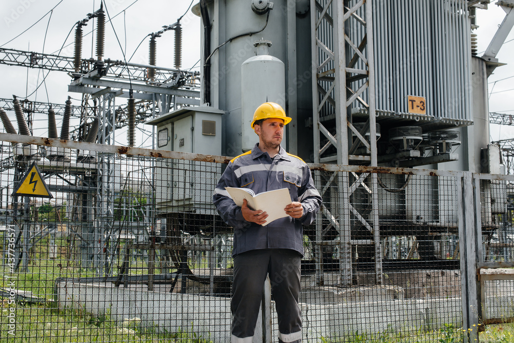 The energy engineer inspects the equipment of the substation. Power engineering. Industry
