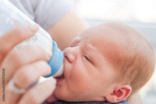 Newborn eating from bottle