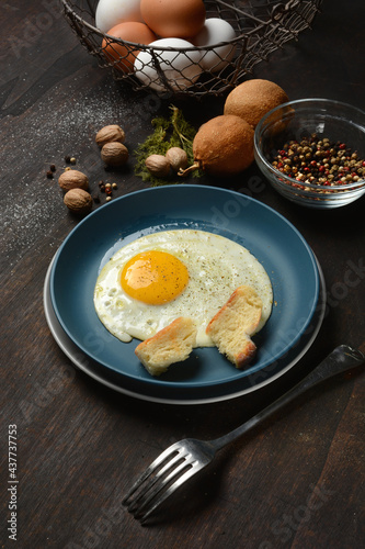 ried egg with ingredients around - dark wooden table - closeup