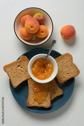 apricot jam with rusk for breakfast - closeup #437737760