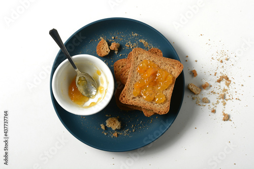 apricot jam with rusk for breakfast - closeup photo