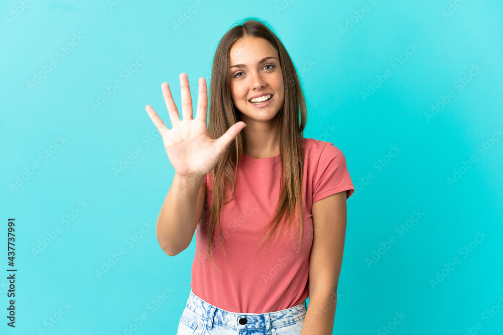 Young woman over isolated blue background counting five with fingers Young woman over isolated blue background counting five with fingers