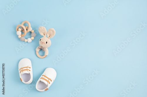 Canvas Gender neutral baby shoes and accessories over blue background