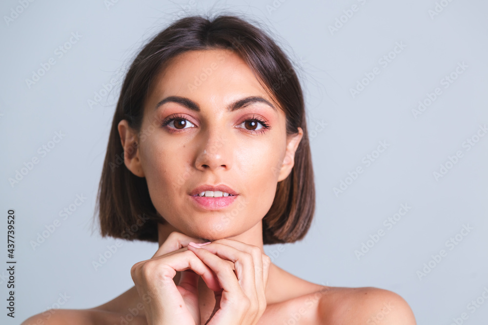 Natural beauty, portrait of topless woman with makeup and soft gentle tanned skin on gray background Natural beauty, portrait of topless woman with makeup and soft gentle tanned skin on gray background