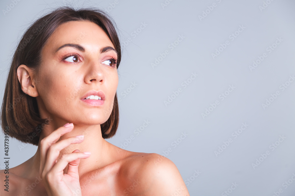 Natural beauty, portrait of topless woman with makeup and soft gentle tanned skin on gray background Natural beauty, portrait of topless woman with makeup and soft gentle tanned skin on gray background