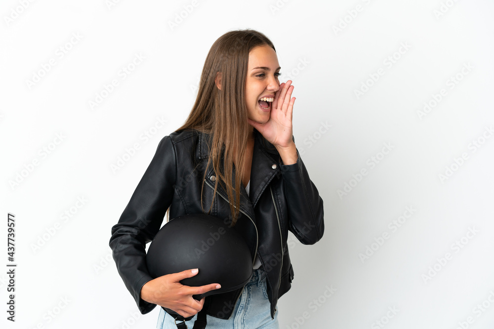 Woman with a motorcycle helmet over isolated white background shouting with mouth wide open to the side Woman with a motorcycle helmet over isolated white background shouting with mouth wide open to the side