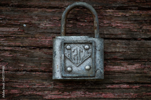 Antique lock on the wooden background. Complete security