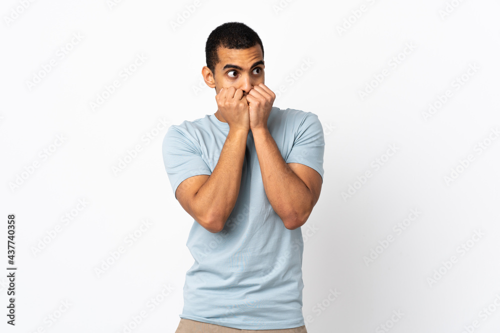 African American man over isolated white background nervous and scared putting hands to mouth African American man over isolated white background nervous and scared putting hands to mouth