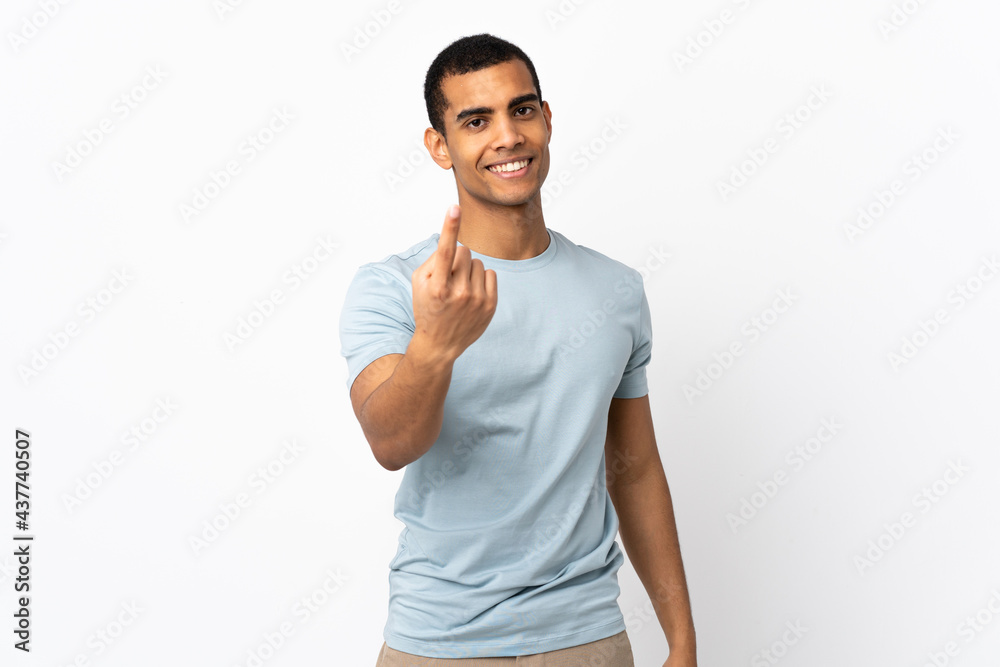 African American man over isolated white background doing coming gesture