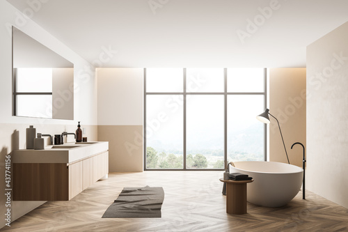 Bathtub and sink with mirror bathroom interior with window and parquet floor