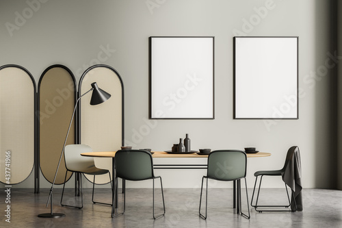 Light grey dining room interior with two posters © ImageFlow
