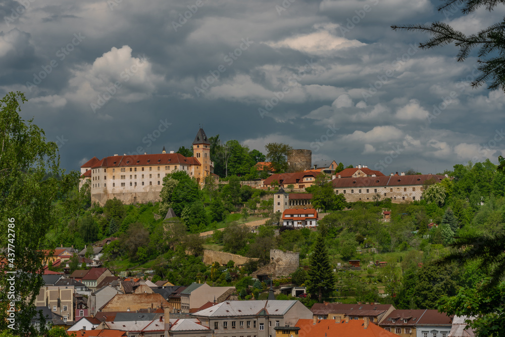 Castle on big hill in Vimperk town in spring sunny and cloudy day
