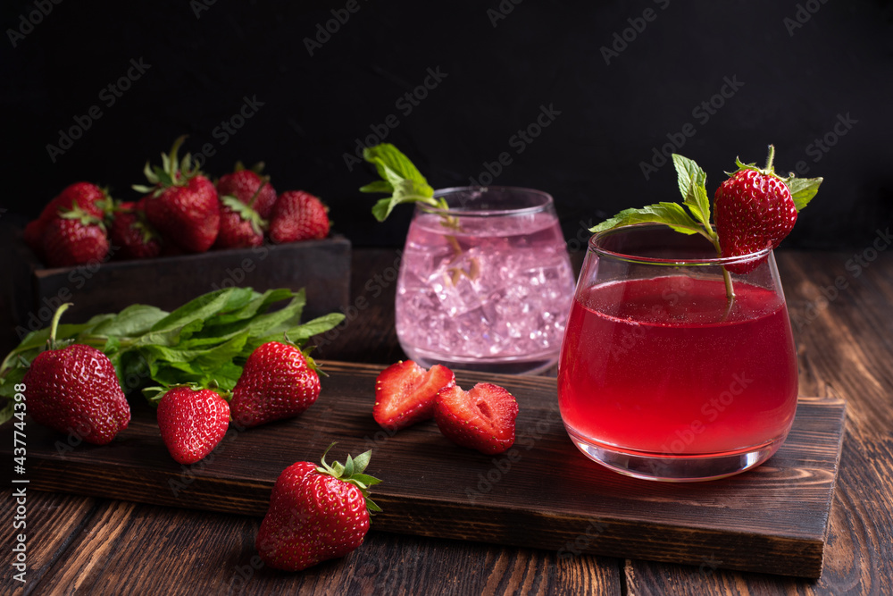 Fruit water, strawberry lemonade with mint sprig with strawberries on a wooden background, summer refreshing drinks concept. Fruit water, strawberry lemonade with mint sprig with strawberries on a wooden background, summer refreshing drinks concept.