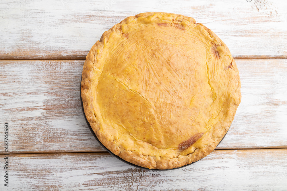 Autumn onion pie and cup of coffee on white wooden background. Top view. Autumn onion pie and cup of coffee on white wooden background. Top view.