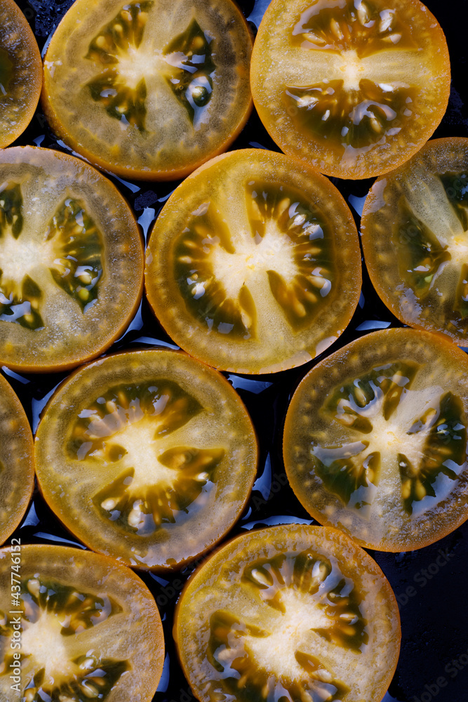 Background of yellow tomatoes cut into circles. Background of yellow tomatoes cut into circles.