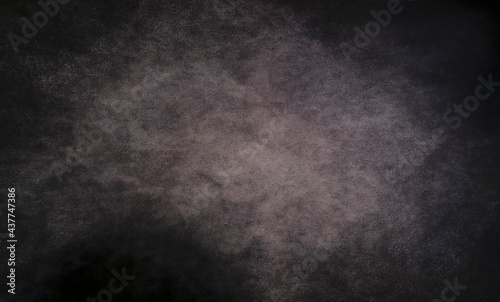 Black abstract background with light center and copy space