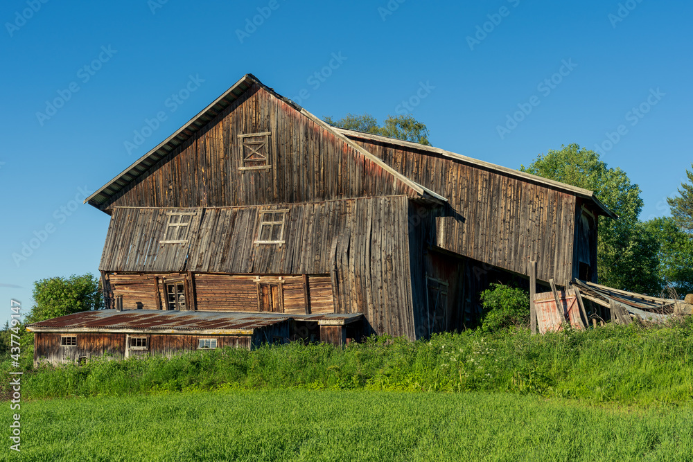 Abandoned farm with collapsing barn in summer. Abandoned farm with collapsing barn in summer.